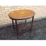 An oval topped occasional table with inlaid decoration, approximately 74 cm x 77 cm x 56 cm.