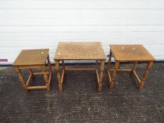 A nest of three occasional tables, largest approximately 50 cm x 53 cm x 40 cm.