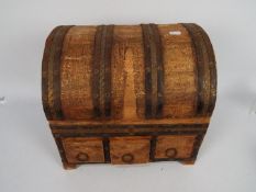 A wooden, metal bound storage chest with