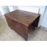 A Victorian oak drop leaf kitchen table,