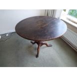 A 19th century oak round tilt-top table