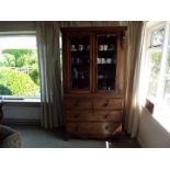 A mahogany twin-door display cabinet wit