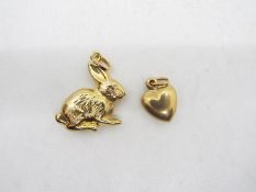 Two 9ct gold charms comprising one in th