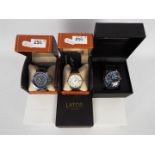 Three boxed fashion watches comprising o