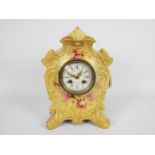 A ceramic cased mantel clock with floral