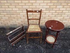 A hall chair with cane seat, an occasional table measuring 63 cm x 40 cm and a magazine rack.