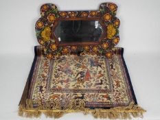 A wood framed wall mirror with floral decoration,