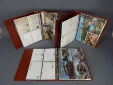 Deltiology - Three binders of postcards including transport / railway interest.