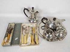 A vintage polished pewter tea set and tray, a quantity of flatware,