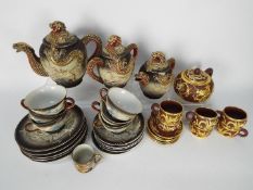 A collection of Oriental tea wares with dragon decoration.