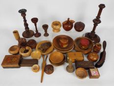 Treen - a good mixed lot of treen to include candlesticks, bowls of various sizes, lidded boxes,