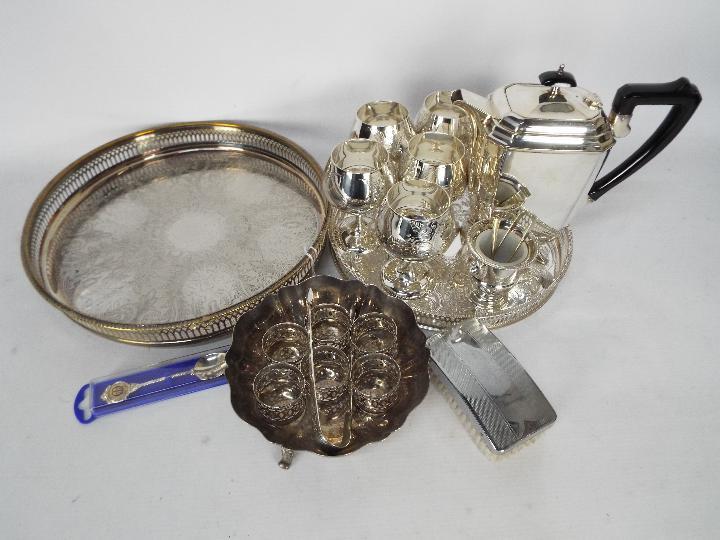 A collection of plated ware to include coffee pot, trays, napkin rings, goblets and similar.