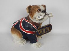 A Welcome sign modelled as a bulldog wearing a Union Flag coat, approximately 35 cm (h).