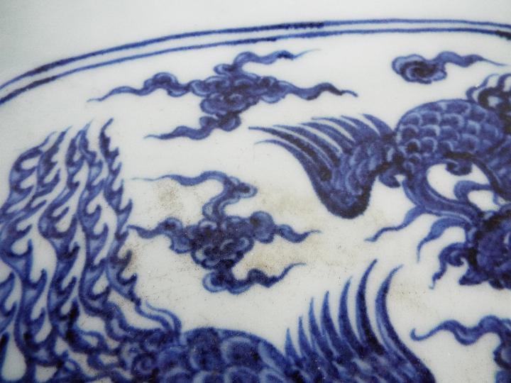 A Chinese blue and white dish decorated with phoenix amongst cloud scrolls, - Image 12 of 12