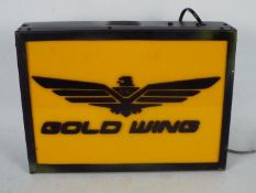 A Gold Wing illuminated light box measuring approximately 30 cm x 42 cm.