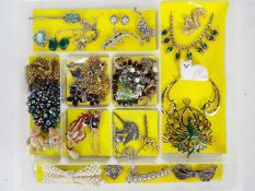 A collection of costume jewellery to include necklaces, rings, brooches and similar,