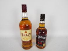 A 75cl bottle of Whyte & Mackay Special and a 1l bottle of Bells, both 40% ABV.