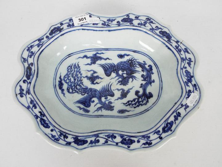 A Chinese blue and white dish decorated with phoenix amongst cloud scrolls,