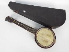 A vintage banjolele in carry case.