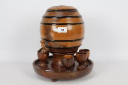A treen spirit barrel on stand with six shot cups, approximately 30 cm (h).