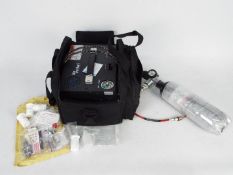 An Air Venturi Nomad II 4500 PSI portable PCP air compressor with various accessories to include