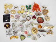 A collection of costume jewellery, predominantly brooches,