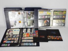 Philately - Two binders, Royal Mail Millennium Collection, mint stamps and first day covers,