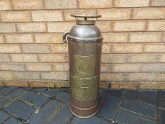 A copper and brass Metropolitan Fire Extincteur by W Rose & Co,