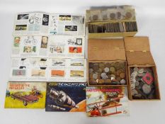 A collection of UK and foreign coins and a collection of tea card albums.