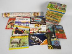 A collection of vintage Ladybird books, a quantity of tea card albums and other.