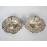 A pair of Victorian silver shallow bowls with pierced and repousse decoration,