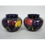 Moorcroft - A pair of small Moorcroft Pottery vases of squat form,
