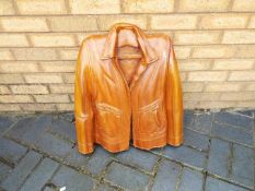 A large hardwood carving in the form of a leather jacket, approximately 63 cm x 56 cm.