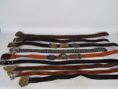 A quantity of vintage leather belts and buckles.