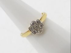 An 18ct yellow gold diamond cluster ring set with seven stones, size M, approximately 3.3 grams.