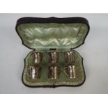 A George V cased set of six silver tots of tyg form, Birmingham assay 1927,