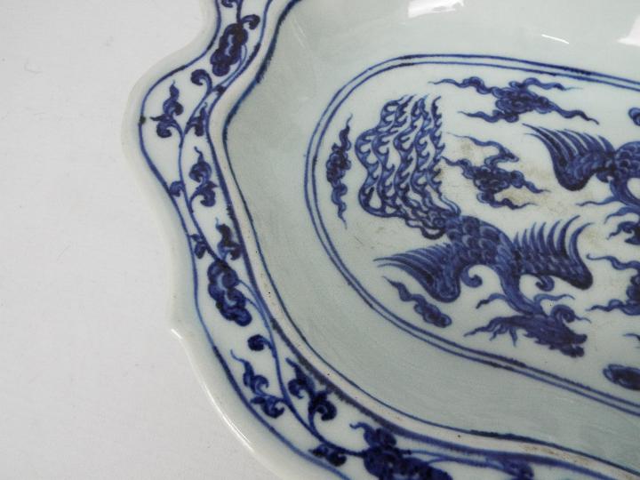 A Chinese blue and white dish decorated with phoenix amongst cloud scrolls, - Image 4 of 12