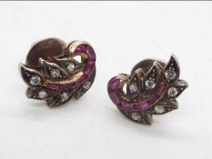 A pair of high purity precious metal earrings set with rubies and diamonds, assessed as 18ct,