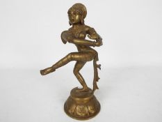 A South Asian bronze figure of a female dancer on lotus base,