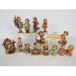 A collection of Hummel figurines and an Authorized Dealer plaque, largest figure 14.