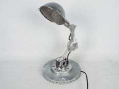 An interesting adjustable desk lamp formed from automotive parts including connecting rods,
