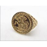 A 9ct gold dress ring in the form of a sovereign, embossed St George Medal, size Y, approximately 4.