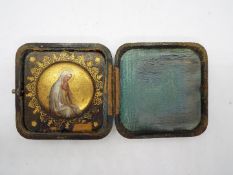 A 19th century miniature depicting the Madonna in folding leather and silk case.