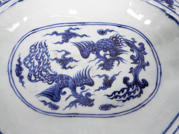 A Chinese blue and white dish decorated with phoenix amongst cloud scrolls, - Image 2 of 12