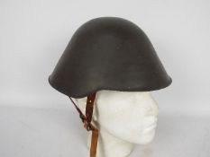 An East German M56 / 76 steel combat helmet with liner.