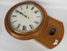 A late 19th/ early 20th century oak drop dial wall clock,