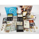 A quantity of UK and foreign banknotes, commemorative coins, limited edition coin sets,