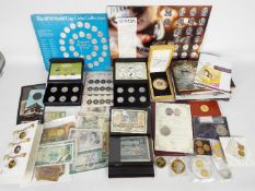 A quantity of UK and foreign banknotes, commemorative coins, limited edition coin sets,
