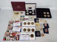 A collection of limited edition World War Two commemorative coins, predominantly gold plated.