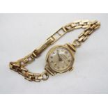 A lady's 9ct gold cased wrist watch on 9ct gold strap, 17.7 grams all in.